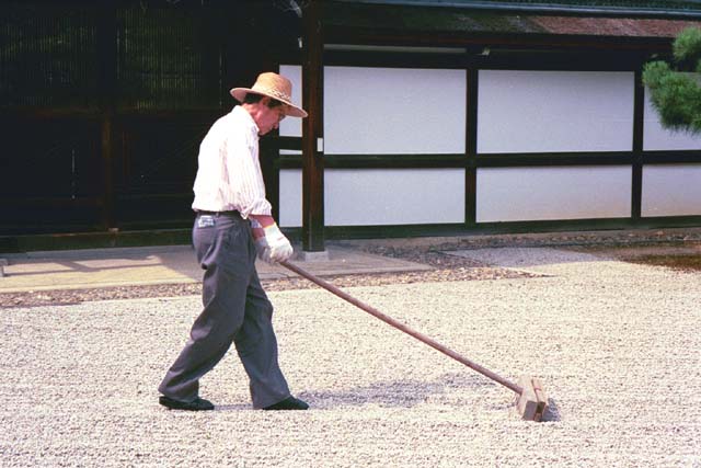 Gardener at Ninnaji raking stone garden